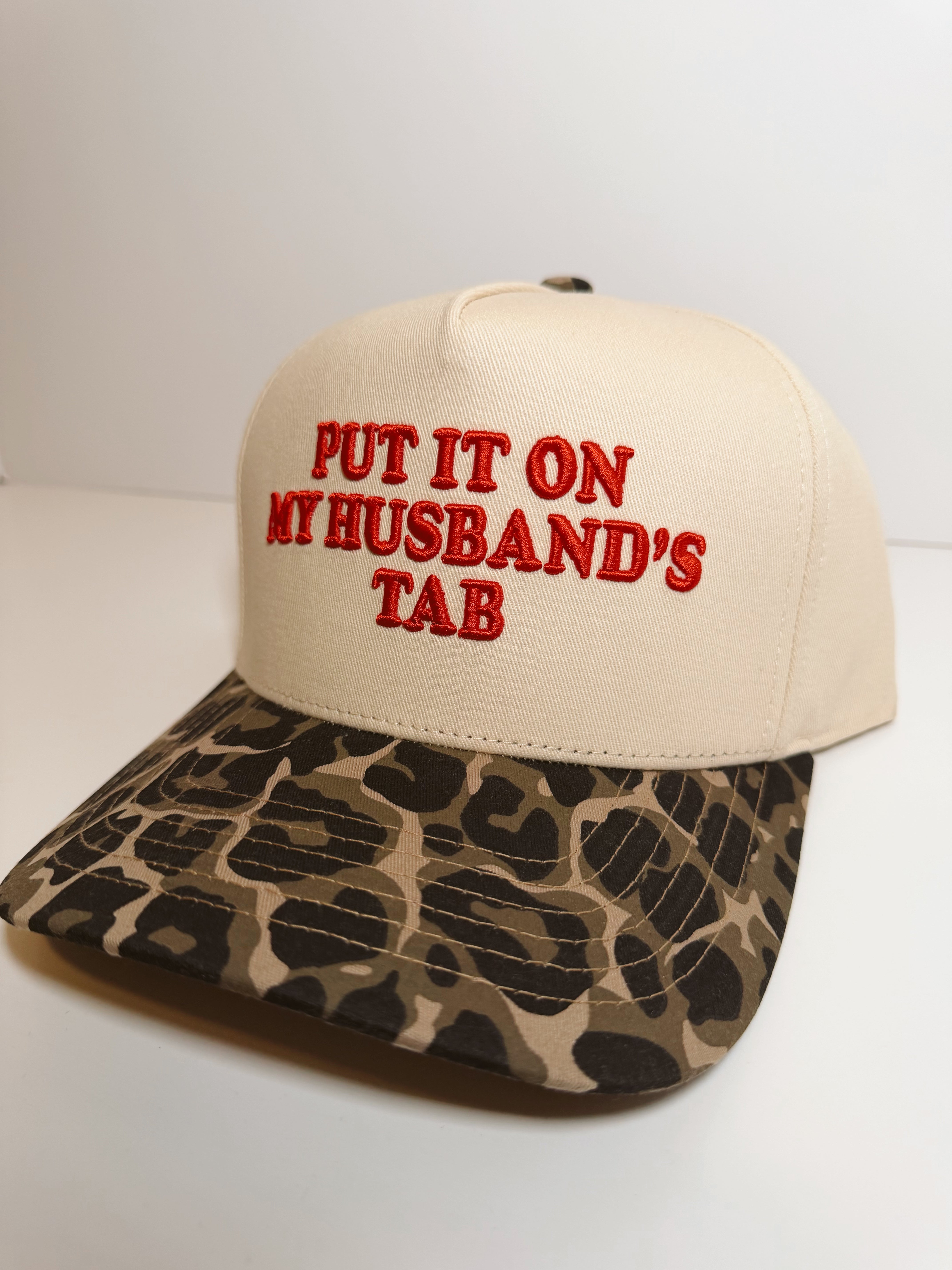 Put It On My Husbands Tab Trucker Hat