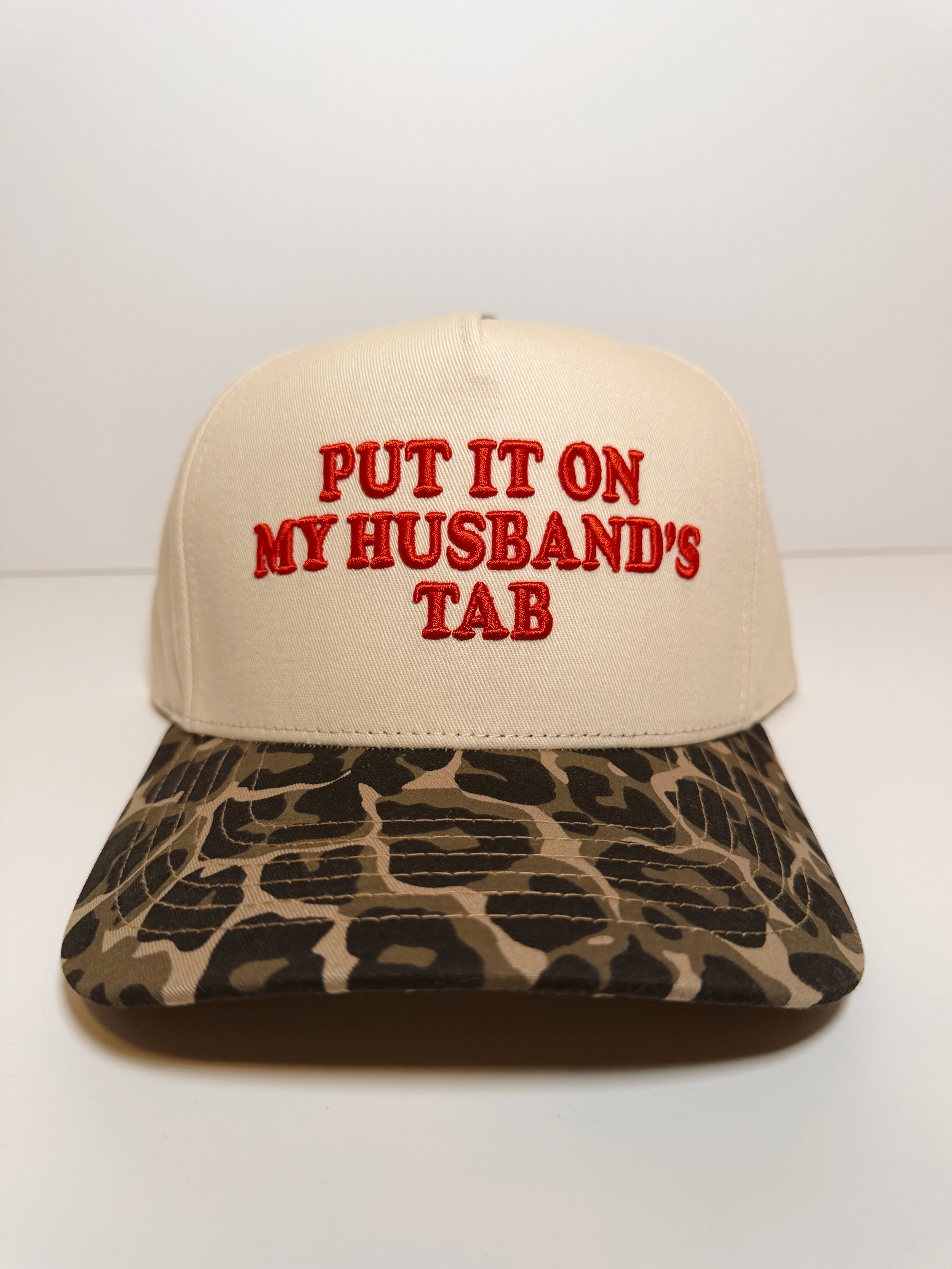 Put It On My Husbands Tab Trucker Hat